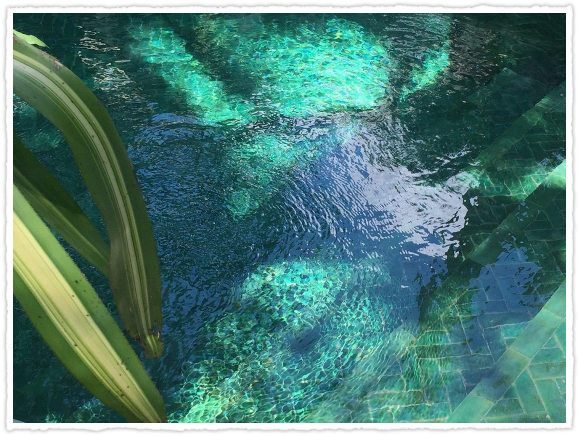 ripples of water across a blue-green tiled pool